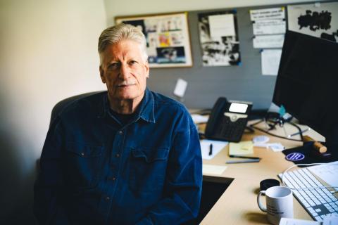 Ben Wright sits in his office and poses for the camera.